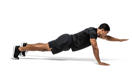 Wear showing man in black athletic wear performing a plank with one arm extended on white...