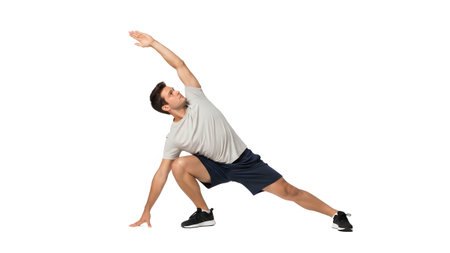 Upwards showing man in side lunge stretch pose with arm extended upwards on white background....の写真素材