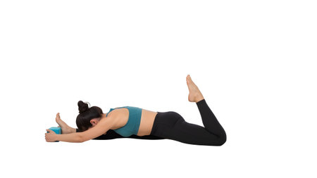 Woman in teal sports bra and black leggings uses a blue yoga block for a deep seated split stretch.