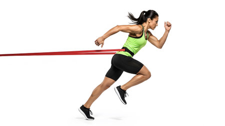 Woman athlete in bright green tank and black shorts sprints forward with red band on white.