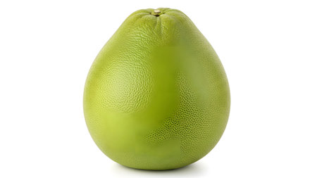 With showing green pomelo fruit with textured skin and stem on white background isolated.