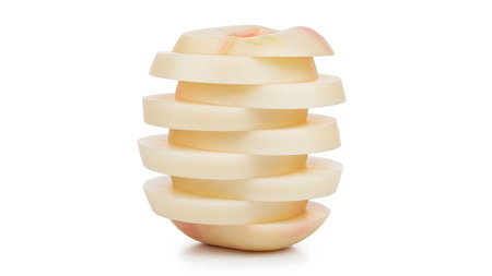 A tall stack of seven sliced white peach rings, exhibiting subtle pink blush and smooth texture...の写真素材