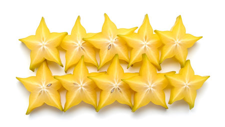 showing ten sliced star fruits arranged in two rows on white background.