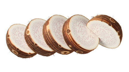 Sliced showing sliced taro root rings with purple veins and brown textured skin on white...の写真素材