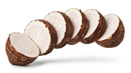 Multiple slices of taro root curve across the frame, showing their purple patterned flesh and...の写真素材