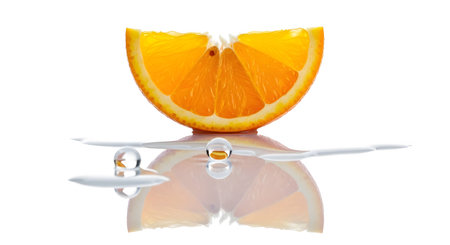 Orange showing two clear water droplets rest on a reflective surface next to a bright orange...の写真素材