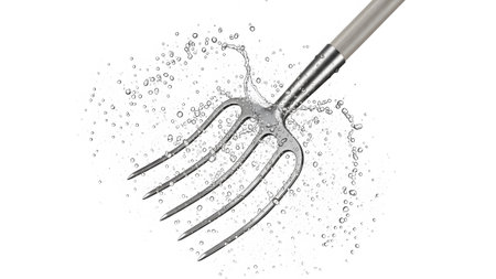 A metal garden pitchfork is captured mid-splash with water droplets flying dynamically against a...