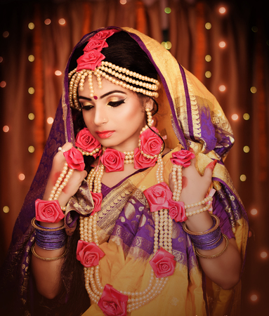 Indian wedding. Morning preparations . Portrait of attractive Hindu bride with deep dark eyesの写真素材