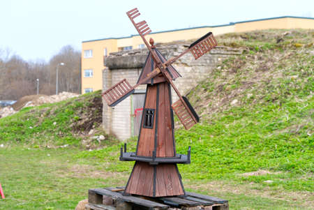 decorative windy mill against the background of green grass in estoniaの写真素材
