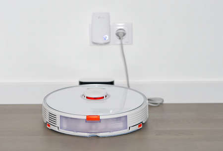Tallinn, Estonia - October 10, 2021: Xiomi s7 roborock vacuum cleaner on charging dock station. close upのeditorial素材