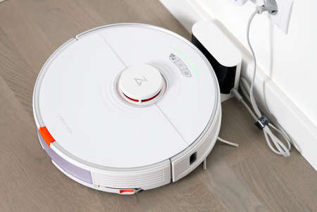 Tallinn, Estonia - October 10, 2021: Xiomi s7 roborock vacuum cleaner on charging dock station. close upのeditorial素材