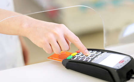 Moment of payment with a credit card through bank terminal machine. close up