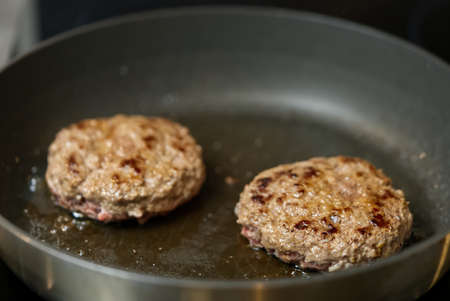 hamburger meat grilling for burgers. Homemade cutlets in frying pan. close upの写真素材