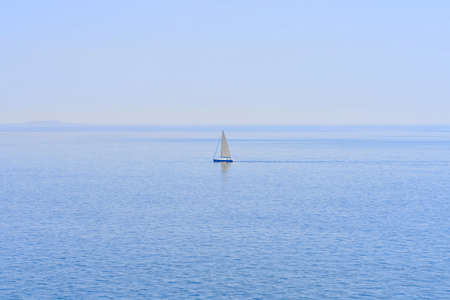The lonely sailboat on the horizon in sea. close up