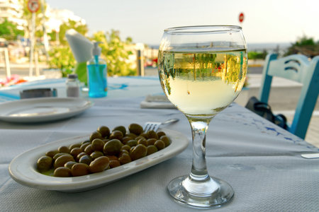 wine and olives in a greece restaurant. close upの写真素材