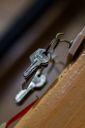 Keys hanging on a wooden surfaceの写真素材