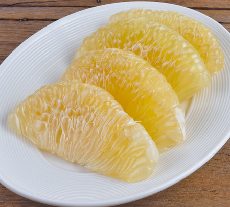 slices of fresh grapefruit on a plate.の写真素材