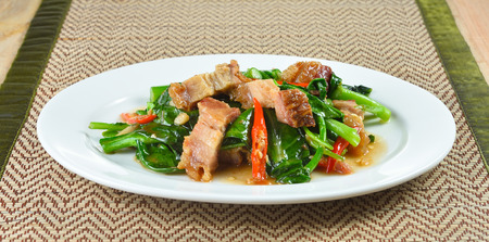 fried chinese broccoli   with crispy porkの写真素材