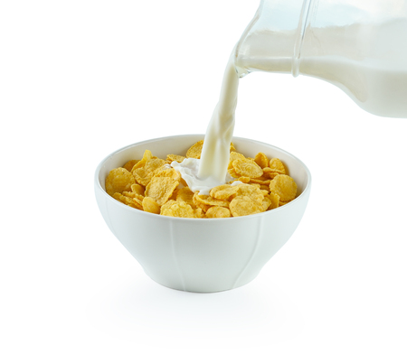 tasty cornflakes in white  bowl and glass of milk on white backgroundの写真素材