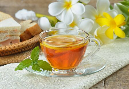 cups of tea with mint on wooden tableの写真素材