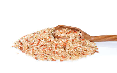 Pile of whole brown rice isolated on white backgroundの写真素材