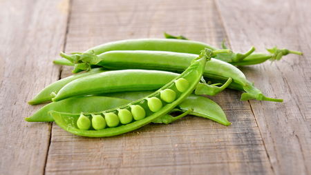 fresh green pea on wooden backgroundの写真素材