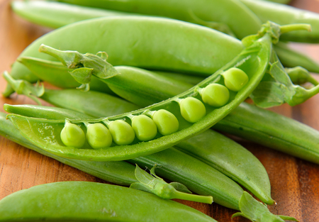 fresh green pea on wooden backgroundの写真素材