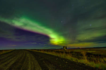 Northern lights Aurora borealis reflection across a lake in Iceland.の写真素材