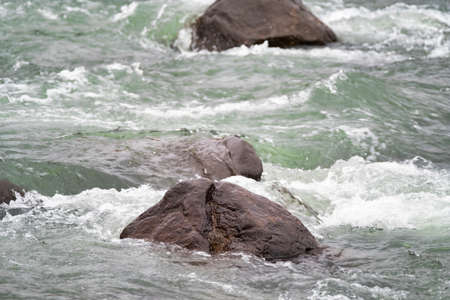 Rjukandi falls with rocks in valley near Egilsstadirの写真素材
