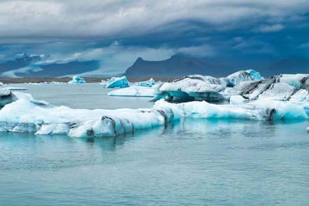 Icebergs floating in the cold water of the Jokulsarlon glacial lagoon. Vatnajokull National Park, in...