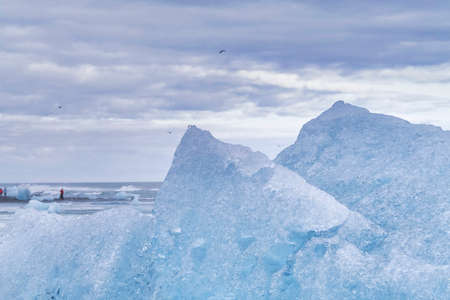 Ice rock with black sand beach at Jokulsarlon beach, Diamond beach in southeast Icelandの写真素材