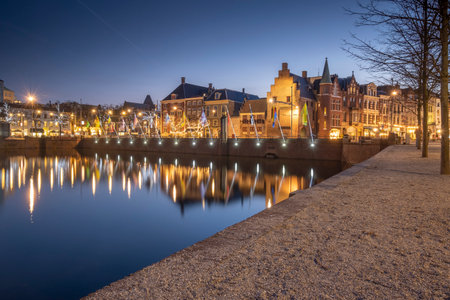 The Hague - February 17 2019: The Hague, The Neherlands. A cozy street with cafes in the center of The Hague, with the Hofvijver in the foreground. The Hague, Den Haag, The Netherlandsのeditorial素材