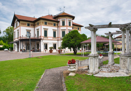 MOGLIANO VENETO. ITALY. JULY 2, 2017: A nice look at Hotel Villa Stucky, with high white-red pillars at the entrance in Mogliano Veneto. Italiaのeditorial素材