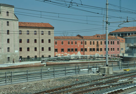 Venice, Italy - July 1, 2017: A view of the colorful Venetian houses, seen from behind a train window, in Venice, Italyのeditorial素材