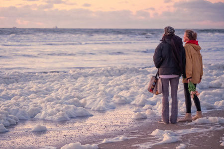 Scheveningen, May 14 2020: Scheveningen, The Netherlands. Two women emotionally throw flowers in the...