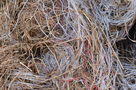 Pile of garbage, plastic threads or packing material of straw in a large pile. many colors of waste...