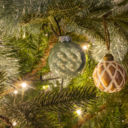 Nice detail picture of a part of a Christmas tree with Christmas decorations. Square christmas card 2020.の写真素材