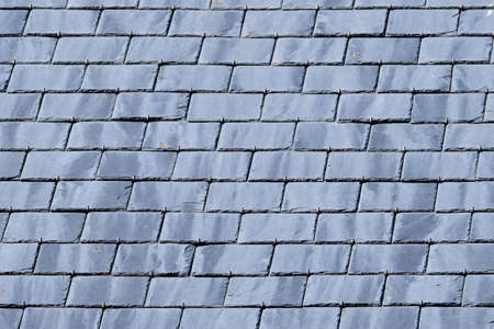 Gray background of roof with slate tiles. close-up and full screen.