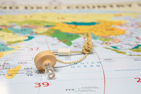 Hoogkerk, Netherlands, November 10 2021: A crystal glass earphone, with cord, beige color. With plug or connection. Crystal earphones, Lies isolated on world map. Radio Maps, Prefix Maps, World Maps, DX Map of the World.のeditorial素材