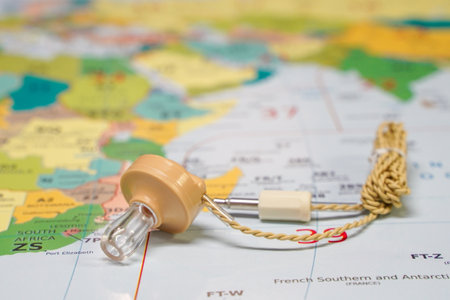 Hoogkerk, Netherlands, November 10 2021: A crystal glass earphone, with cord, beige color. With plug or connection. Crystal earphones, Lies isolated on world map. Radio Maps, Prefix Maps, World Maps, DX Map of the World.のeditorial素材