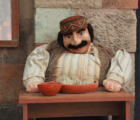 Little Puppet in the Entrance of Restaurant Greeting and Inviting Tourists to Eat Khinkali, Old Tbilisi, Georgiaのeditorial素材