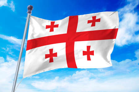 Flag of Georgia developing against a clear blue skyの写真素材