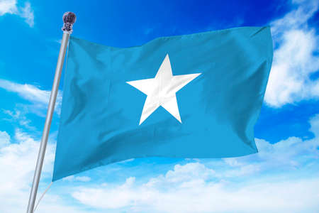 Flag of Somalia developing against a clear blue skyの写真素材