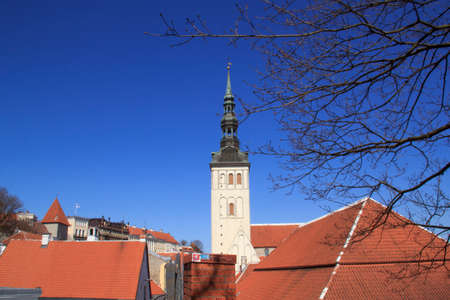Beautiful view of the maiden's tower with the next fortress wall and the dome of the tower Oleviste Church in Tallinn, Estonia on a sunny dayの写真素材