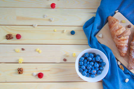 A nutritious healthy breakfast of croissants and berriesの写真素材