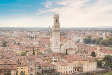 Beautiful view of the Lamberti Tower and Ponte Pietra on the banks of the Adige River in Verona,...