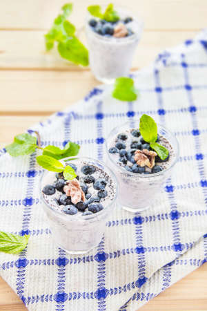Juicy and fresh blueberries with green leaves. Creative atmospheric decoration