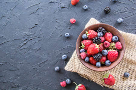 A healthy serving of fresh summer berries. Creative atmospheric decorationの写真素材