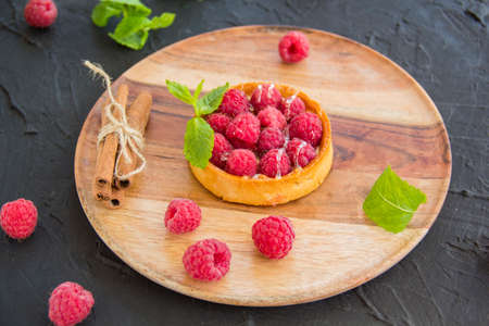 A healthy tasty dessert of cheese raspberry tart. Creative atmospheric decorationの写真素材