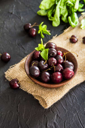 A healthy serving of fresh sweet cherries. Creative atmospheric decoration